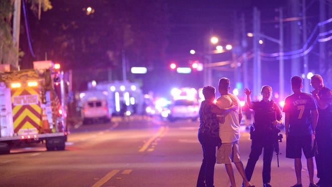 Orlando Police officers direct family members away from a shooting involving multiple fatalities at the Pulse Orlando nightclub in Orlando, Fla., Sunday, June 12, 2016.
