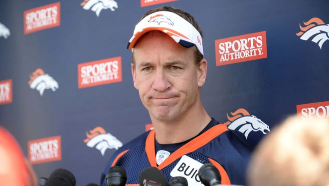 Denver Broncos quarterback Peyton Manning (18) speaks to reporters after mini camp drills at the Broncos practice facility.