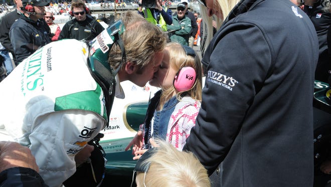 Ed Carpenter kisses daughter ,  Makenna after , qualifying for the Indianapolis 500 mile race  Saturday, Friday  May 17,  2014  at The Indianapolis Motor Speedway.