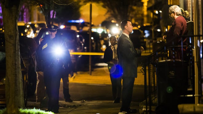 Police investigate the scene of a shooting in the 1100 block of Elm Street in Wilmington on March 30. Candidates for mayor are scheduled to debate public safety issues Thursday.