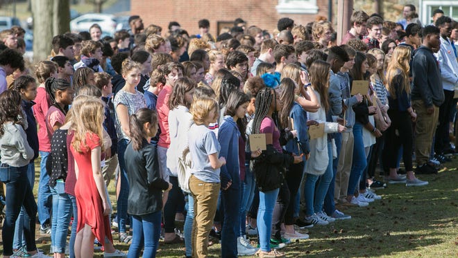 Over 150 students at Wilmington Friends School gathered under the school's American flag at noon for 17 minutes, one minute for every life lost in the mass shooting at Marjory Stoneman Douglas High School in Parkland, Florida.