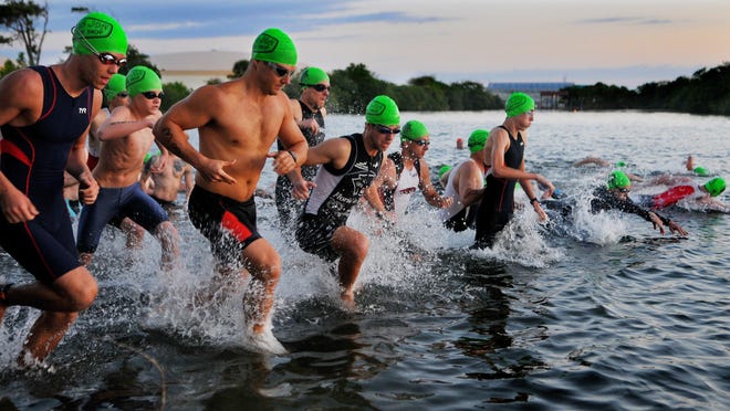 Athletes head into the Banana River during the 2015 Cocoa Beach Triathlon. Water tests have cleared hurdles that say participants are OK to swim in this year’s event.