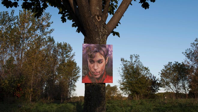 A portrait of Prince by artist Daniel Lacey hangs outside Paisley Park in Chanhassen, Minn, on October 6, 2016.
