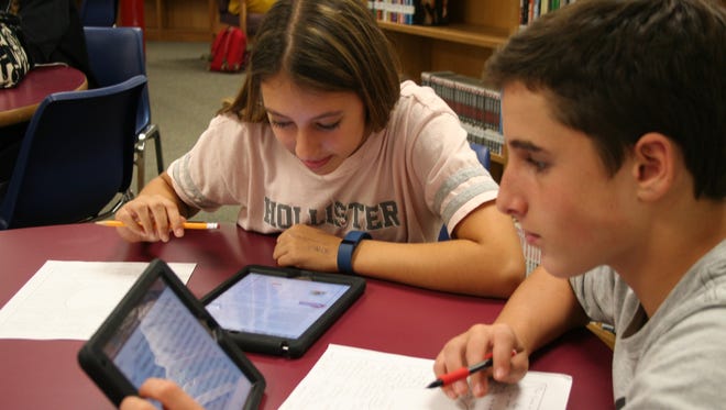 Del Val freshmen Elizabeth Flower and Cooper Gill, both of Alexandria Township, use their iPads to access information on Chinese dynasties for their World History class.