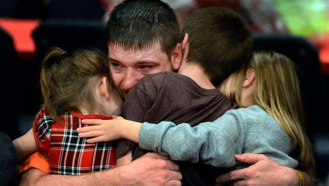 Rutherford County Correctional Facility inmate Ryan Goad comforts his children as they say goodbye at the end of Operation Bless A Child at the New Vision Student Center on Saturday, Dec. 12, 2015, in Murfreesboro, Tenn. 