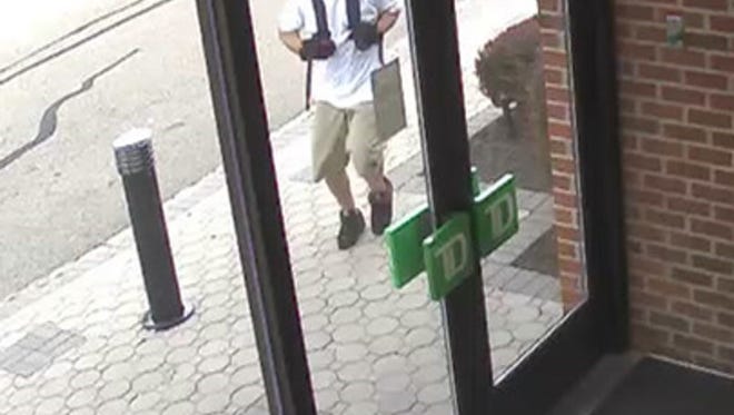 Surveillance photos released by authorities show a man suspected of robbing the TD Bank branch on Mount Hope Avenue in Rockaway township entering the branch.