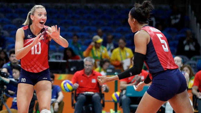 Team USA's Jordan Larson, left, celebrates with teammate Rachael Adams during a women's preliminary match against Italy at the 2016 Summer Olympics in Rio de Janeiro, Brazil. The three-time Olympic medalist has left Texas' coaching staff, where she was serving as a volunteer assistant.