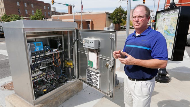 Andy Milam shows the interior of a traffic controller cabinet Wednesday, September 21, 2016, at the corner of Sixth and Columbia streets in downtown Lafayette. MIlam, who is IT Director for the City of Lafayette, said the public Wi-Fi network is run through the same fiber optic cables as the traffic control network.