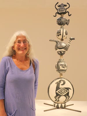 First place winner Julie Szerina Stein poses with her winning piece Mimbres Totem.