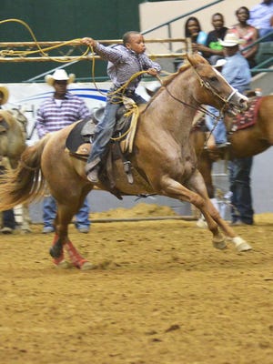 Elgin Kelly of Terry gives chase during Saturday's 17th Annual Mississippi Black Rodeo junior breakaway event at the Mississippi Coliseum in Jackson.
