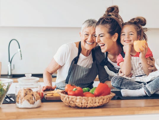 Three generations, laughing women in the kitchen