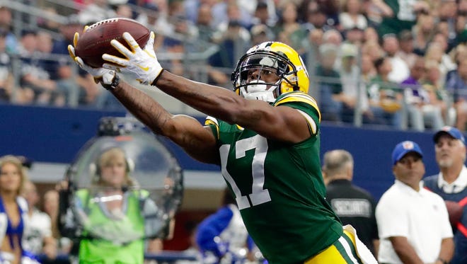Green Bay Packers receiver Davante Adams hauls in a touchdown pass from Aaron Rodgers in the first quarter of Sunday's game in Arlington, Texas.