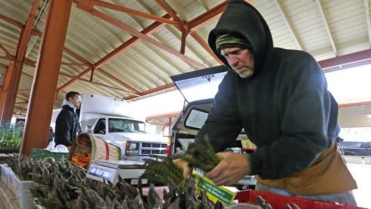 David Witte, of West Bend, Wis., sells early-season produce asparagus and spinach from his farm at a farmers market. Western states are struggling through a drought which is affecting the agriculture industry because of its reliance on irrigation.