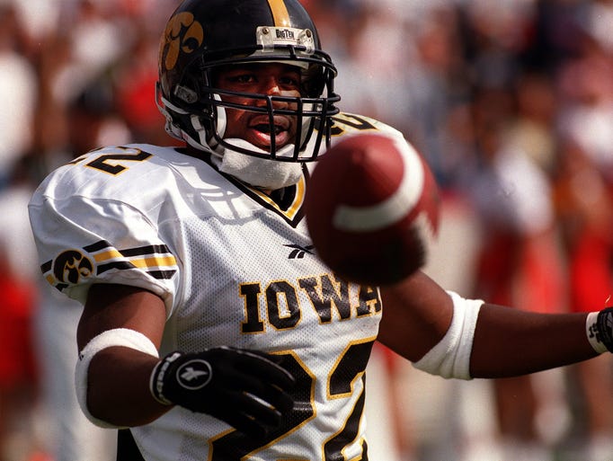 Iowa running back Tavian Banks flips the ball to an