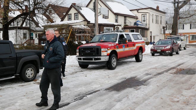 Yonkers Fire Department personnel survey houses in south Buffalo, N.Y. for structural damage on Sunday, Nov. 23, 2014. Western New York continues to dig out from the heavy snow dropped this week by lake-effect snowstorms.