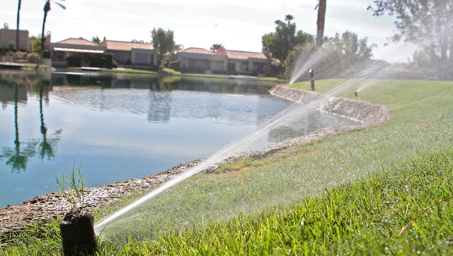Sprinklers run in July 2013, keeping the lawns green in a neighborhood in Rancho Mirage.