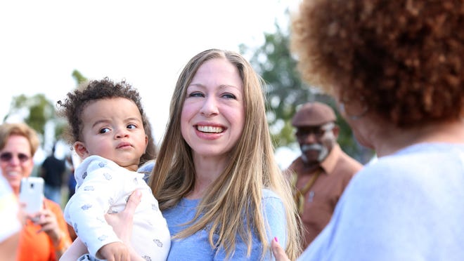 Chelsea Clinton holds nine-month-old Quinn Beverly of Desert Hot Springs during the Day of Action community event at the James O. Jessie Desert Highland Unity Center in Palm Springs on Sunday.