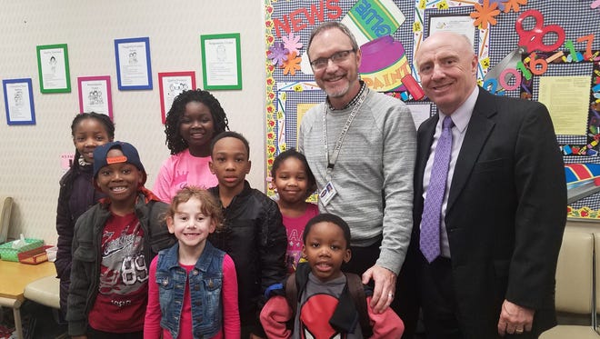 Farmington/Farmington Hills Multicultural Multiracial Community Council Rainbow Award honoree Robert Kauffman, principal at Hillside Elementary School,  is pictured with some of his students.