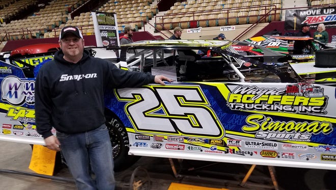 Green Bay native Jared Siefert poses next to his 2018 Lazer chassis that was on display at NEW Motorama at Shopko Hall in March. Siefert will compete for the Dirt Kings Tour late model championship this season.