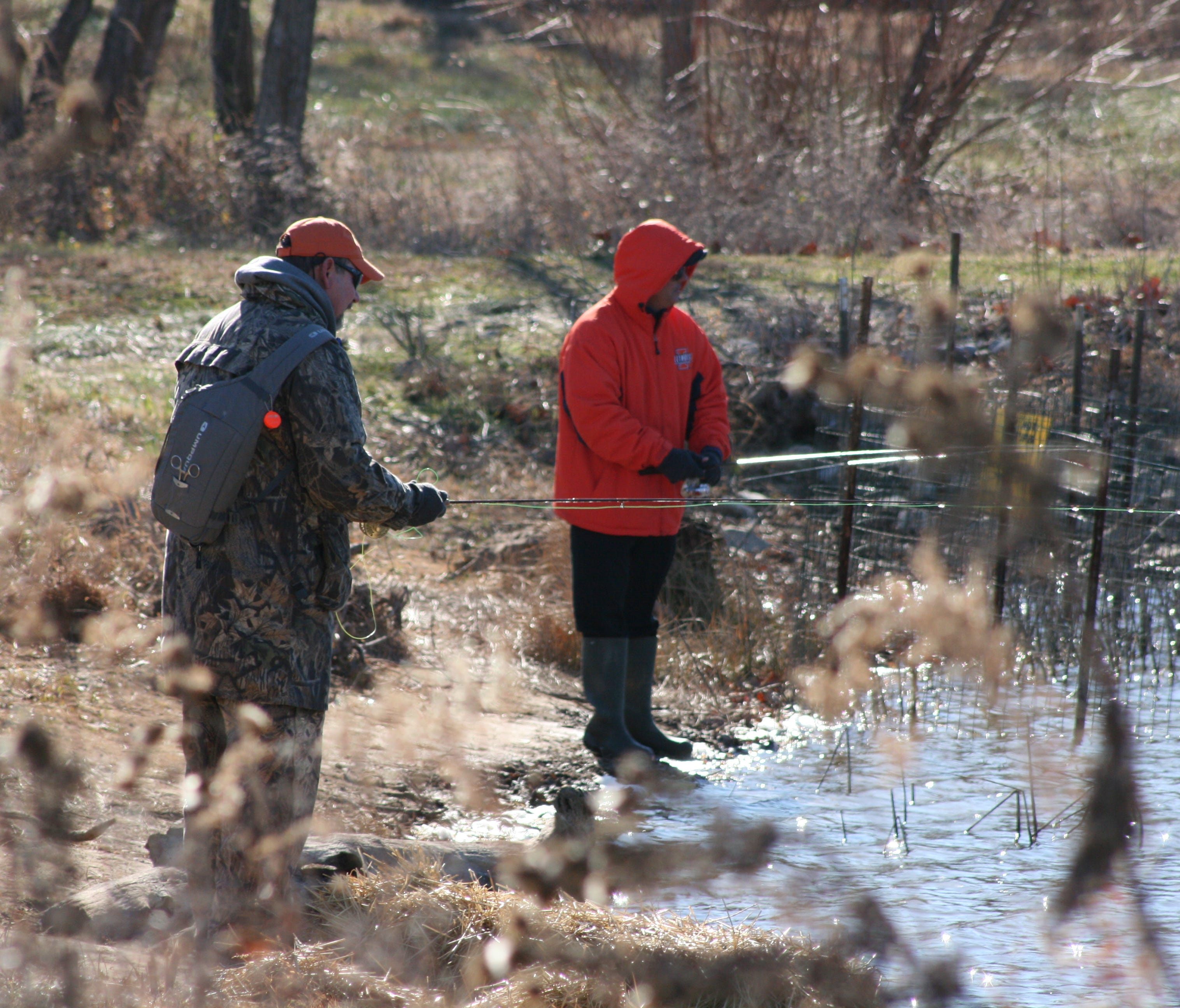 Fishermen share a slice at water on one of five ponds managed as winter trout fisheries by the Missouri Department of Conservation.
