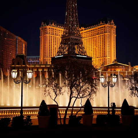 A woman watches the fountains at the Bellagio hote