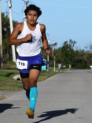 17-year-old Cipriano Martinez races toward the finish line ahead of the pack. Martinez won first place in the Male Open category of the Kiwanis Family 5K on Saturday, Nov. 18, 2017.
