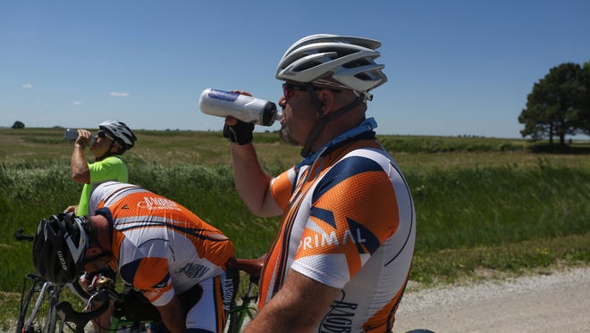 Craig Cooper, a member of the RAGBRAI route inspection team, takes a drink of water while riding the optional gravel loop near Imogene on Sunday, June 5, 2016.