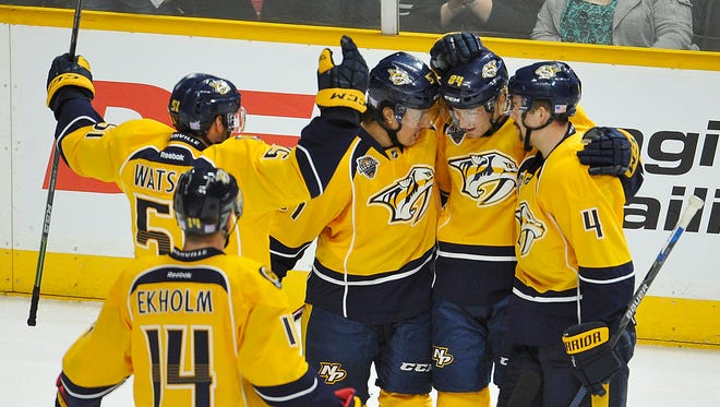 The Predators celebrate a goal by Colton Sissons, second from right, in the first period Tuesday.
