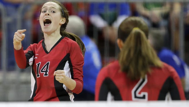 Newman Catholic's Lauren Shields (14)  celebrates after the Fighting Cardinals won a point against Seneca in a Division 4 semifinal at the WIAA state girls volleyball tournament at the Resch Center on Friday, November 4, 2016, in Ashwaubenon, Wis. Newman Catholic won the match 3-0 to advance to Saturday's D4 championship match.