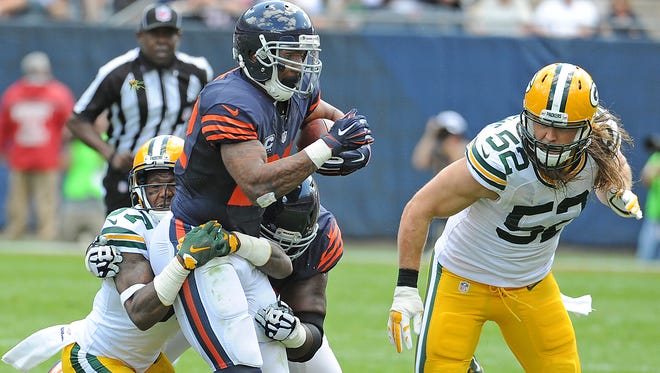 Packers defenders Sam Shields (37) and Clay Matthews (52) converge on Bears running back Matt Forte (22) at Soldier Field.