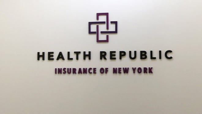In this photo taken Nov. 18, 2015, a business logo adorns the wall outside the offices of Health Republic Insurance of New York.