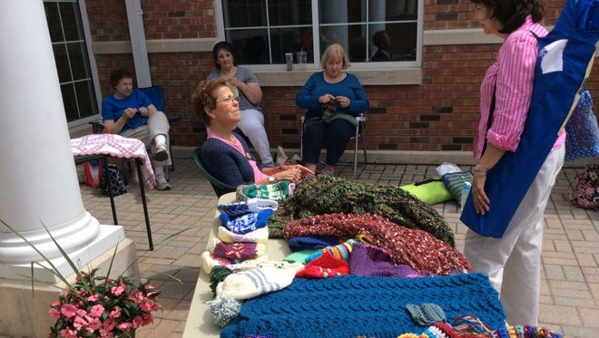 Every year, the Gates Avenue Knitters gather on the plaza or in the atrium of the Long Hill Township Library for World Wide Knitting in Public Day. They love having visitors.
