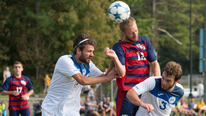 USI senior Kyle Richardville heads a ball during a game against Rockhurst in 2016.