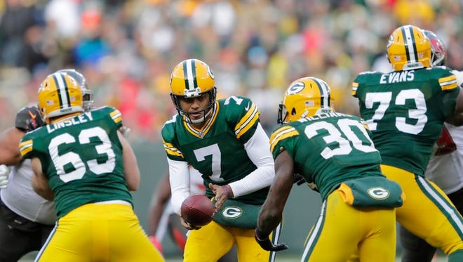 Green Bay Packers quarterback Brett Hundley (7) hands the ball off to running back Jamaal Williams (30) against Tampa Bay Sunday, December 3, 2017, at Lambeau Field in Green Bay, Wis.