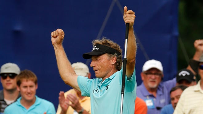 Bernhard Langer celebrates after sinking a birdie putt on the 18th green on the second hole of a sudden death playoff with Jeff Sluman to win the Senior Players Championship in Pittsburgh on Sunday, June 29, 2014.
