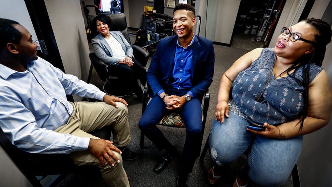 Alice Marie Johnson (second left) jokes with family members including (left to right) son Charles Johnson, grandson Justin Johnson and daughter Catina Scales at her lawyers offices in Memphis, Tenn, On Wednesday, President Trump commuted Johnson's life sentence after 21 years in prison for a first-time drug offense. Kim Kardashian West spearhead the effort for Johnson's release. 