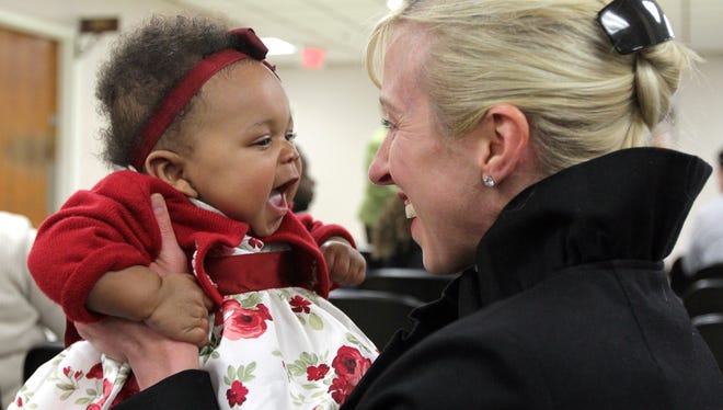 Megan Steel, Highlands, holds her daughter Zoey, 7 months, at the Monmouth County Courthouse in Freehold Friday afternoon.  Her adoption was later finalized by the courts.    FREEHOLD, NJ   12/7/12  ADOPTIONDAY1207A   ASBURY PARK PRESS PHOTO BY THOMAS P. COSTELLO