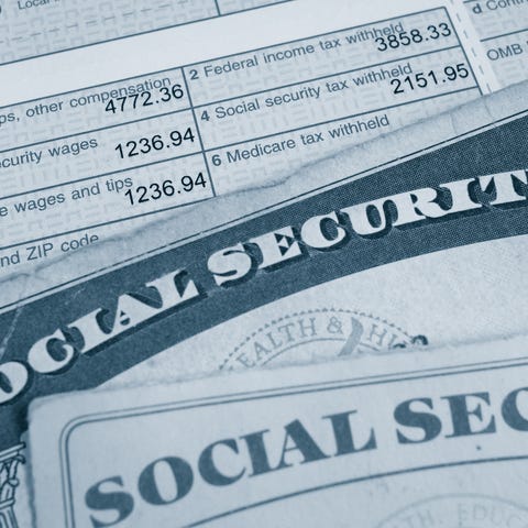 Two Social Security cards lying atop a W2 tax...