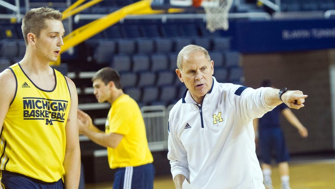 Michigan Wolverines coach John Beilein gives instructions to forward Mark Donnal during a practice session at Crisler Center on Oct. 2.