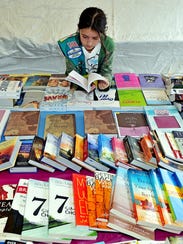 McKinzie Davis, 10, takes a look at books at the Baker