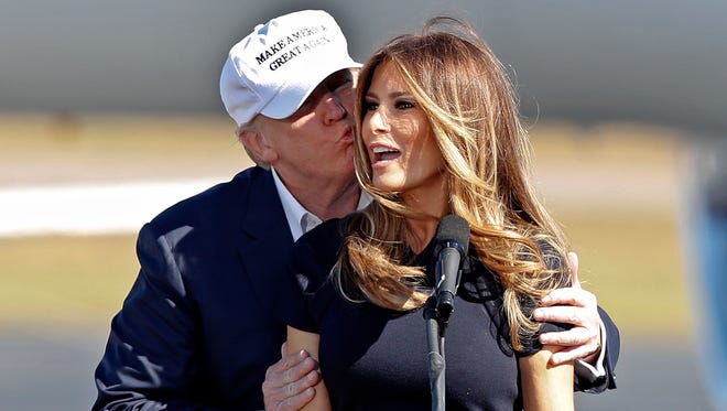 Republican presidential candidate Donald Trump kisses his wife Melania as she introduces him at a campaign rally Saturday, Nov. 5, 2016, in Wilmington, N.C.