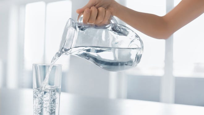 Drink Water. Woman's Hand Pouring Fresh Pure Water From Pitcher Into A Glass. Health And Diet Concept. Healthy Lifestyle. Healthcare And Beauty. Hydratation.