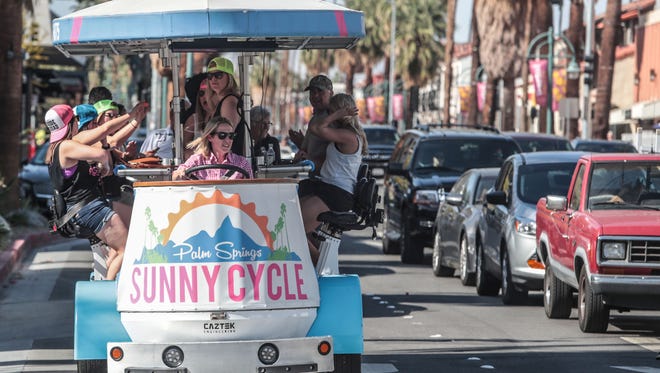 The Sunny Cycle group pedal down Palm Canyon in Palm Springs on Thursday, April 12, 2018. Former Minnesota State University coaches, Shannon Miller and Jennifer Banford, opened the cycle party tour business soon after they were let go from their university coaching jobs for which they filed sexual discrimination and pay inequity lawsuits against the University.