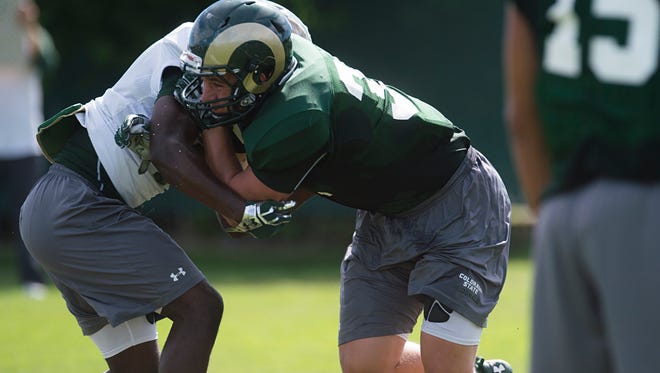 Linebacker Max McDonald, a graduate of Rocky Mountain High School, hits running back Dalyn Dawkins during an Aug. 9  CSU football practice. McDonald is one of a handful of true freshmen who could see more playing time this week, coach Mike Bobo said.