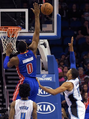 Detroit Pistons center Andre Drummond (0) blocks a shot by Orlando Magic forward Tobias Harris (12) as Elfrid Payton (4) watches during the first half of an NBA basketball game in Orlando, Fla., Tuesday, Dec. 30, 2014.