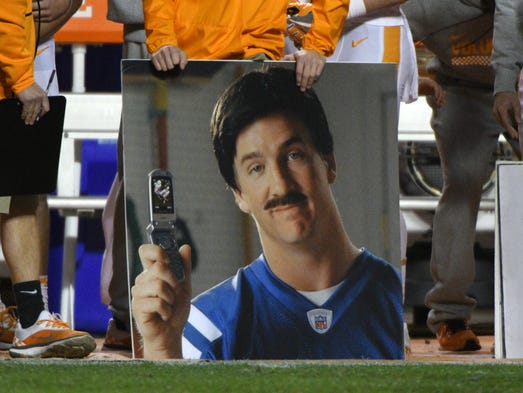 A humorous photo of Peyton Manning sits on the sidelines