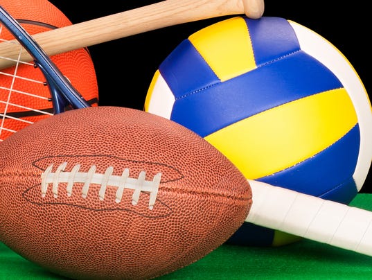 Arrangement of assorted sports equipment on black background