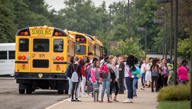 Students are dropped off from buses at Southside Middle School in early August.