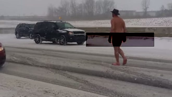 A screen grab shows a man being arrested on I-75 in Auburn Hills Sunday.