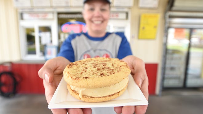 Owner Samantha Wells holds a pumpkin custard Whittie in front of the Zanesville Whit’s Frozen Custard. With the approach of fall, the popularity of pumpkin flavors at Whit’s explodes, says Wells.